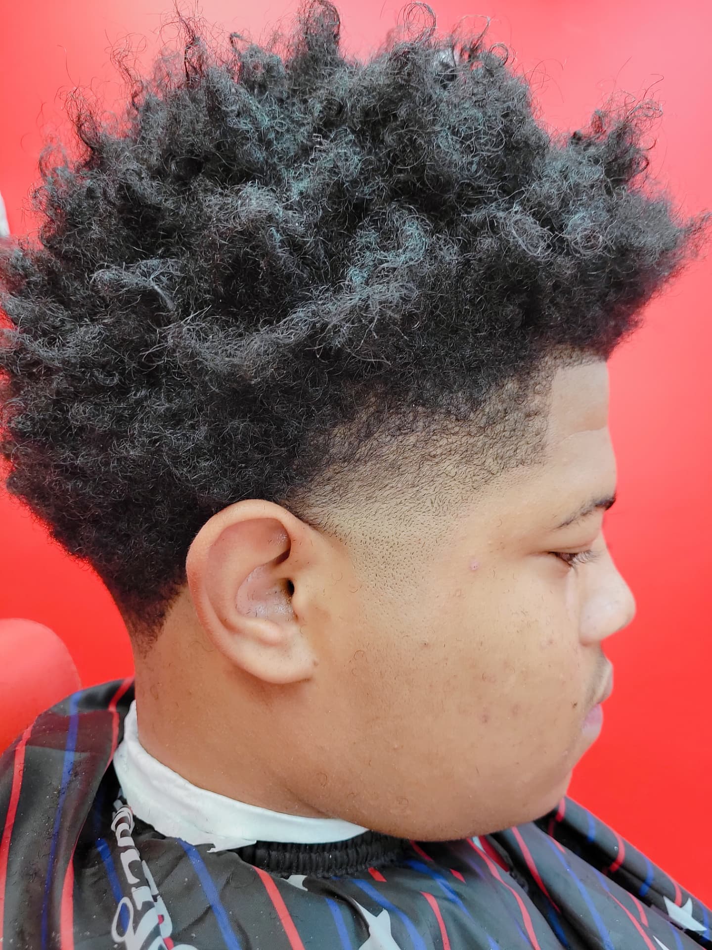 Real CatchYaCut client showing a clean taper fade and natural textured hair